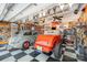 Spacious garage featuring classic cars, checkered floors, and walls decorated with signs at 706 Skinner Rd, Shelby, NC 28152