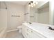 Bathroom features a white double sink vanity and bathtub with shower at 7725 Petrea Ln, Charlotte, NC 28227