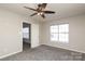 Bedroom featuring carpet flooring, a ceiling fan and window views at 7725 Petrea Ln, Charlotte, NC 28227