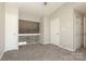 Upstairs carpeted bedroom with neutral walls, trim, and doors; vaulted ceiling adds spaciousness at 7725 Petrea Ln, Charlotte, NC 28227