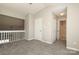 Cozy carpeted bedroom with neutral walls, closet, and natural light from the window at 7725 Petrea Ln, Charlotte, NC 28227