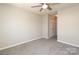 Spacious bedroom featuring soft carpet, ceiling fan, and closet at 7725 Petrea Ln, Charlotte, NC 28227