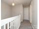 Hallway with white railings, neutral walls and carpeted floors at 7725 Petrea Ln, Charlotte, NC 28227