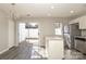 Bright eat-in kitchen with modern appliances, a peninsula bar, access to a deck, and grey toned flooring at 7725 Petrea Ln, Charlotte, NC 28227