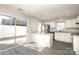 Modern kitchen features stainless steel appliances, gray tone floors, white cabinets, and a sliding glass door to a deck at 7725 Petrea Ln, Charlotte, NC 28227