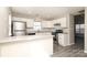 Modern kitchen with white cabinetry, stainless appliances, grey tone flooring, and a breakfast bar at 7725 Petrea Ln, Charlotte, NC 28227