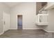 Well-lit living room with grey toned flooring, a view to the stairway and entrance door, and high vaulted ceiling at 7725 Petrea Ln, Charlotte, NC 28227