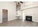 View of the fireplace, two story wall, grey tone flooring, and second story railing in a bright and airy living room at 7725 Petrea Ln, Charlotte, NC 28227