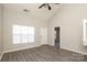 Spacious, naturally lit living room featuring vaulted ceilings, grey tone flooring, and a view of the front door at 7725 Petrea Ln, Charlotte, NC 28227