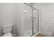 Bathroom featuring a toilet and walk-in shower with glass door and modern fixtures at 8109 Jacey Ln # 40, Huntersville, NC 28078