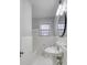 Clean, well-lit bathroom with white tile, classic fixtures, and a pedestal sink at 924 S Main Ave, Newton, NC 28658