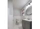 Bathroom with tiled walls and floors, and a gray vanity at 924 S Main Ave, Newton, NC 28658