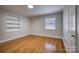 Inviting bedroom with hardwood floors, built-in shelving, and natural light from two windows at 924 S Main Ave, Newton, NC 28658