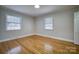 Bright bedroom featuring hardwood floors, neutral walls, and two windows for natural light at 924 S Main Ave, Newton, NC 28658