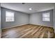 Spacious bedroom showcasing modern vinyl floors and two windows for ample natural light at 924 S Main Ave, Newton, NC 28658
