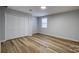 Bedroom featuring plank floors, a window, and a large closet at 924 S Main Ave, Newton, NC 28658