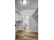 Walk-in closet with plank floors and built-in shelving and a view to the bathroom at 924 S Main Ave, Newton, NC 28658