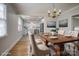 Elegant dining space with a wood table, chandelier and adjacent modern kitchen at 924 S Main Ave, Newton, NC 28658