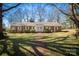 Beautiful brick home with manicured lawn and a classic brick walkway to the front door at 924 S Main Ave, Newton, NC 28658