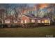 Beautiful brick home featuring manicured lawn and trimmed hedges in a serene, tree-lined neighborhood at 924 S Main Ave, Newton, NC 28658