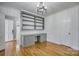 A bright home office showcasing custom built-in shelving and cabinets with hardwood floors at 924 S Main Ave, Newton, NC 28658