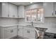 Bright kitchen featuring white cabinets, subway tile backsplash, and stainless steel appliances at 924 S Main Ave, Newton, NC 28658
