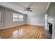 A living room with hardwood floors, fireplace, and a ceiling fan at 924 S Main Ave, Newton, NC 28658