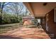 Cozy brick patio overlooking a lush backyard, perfect for outdoor entertaining and relaxation at 924 S Main Ave, Newton, NC 28658