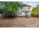 A spacious backyard with a screened porch, patio with seating, and well-maintained lawn at 10230 Blackstock Rd, Huntersville, NC 28078