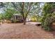 Spacious backyard featuring a swing set, seating, and mature trees at 10230 Blackstock Rd, Huntersville, NC 28078