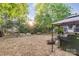 Expansive backyard featuring mature trees, a seating area, and a lush lawn at 10230 Blackstock Rd, Huntersville, NC 28078
