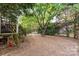 Large backyard features lush greenery, privacy fence, and mature trees perfect for enjoying the outdoors at 10230 Blackstock Rd, Huntersville, NC 28078