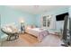 Bright bedroom with blue walls, comfy chair, and a large window at 10230 Blackstock Rd, Huntersville, NC 28078
