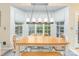 Bright dining area features a large window bay and modern chandelier at 10230 Blackstock Rd, Huntersville, NC 28078