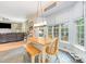 Inviting dining area featuring a wooden table, bench seating, and bright natural light from surrounding windows at 10230 Blackstock Rd, Huntersville, NC 28078