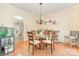 Cozy dining room featuring a glass-top table, chandelier, and hardwood floors for Gathering gatherings at 10230 Blackstock Rd, Huntersville, NC 28078