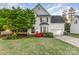 Charming two-story home with a well-manicured front lawn, mature tree, and inviting curb appeal at 10230 Blackstock Rd, Huntersville, NC 28078