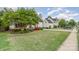 A charming two-story home with mature trees and a well-maintained lawn in a suburban neighborhood at 10230 Blackstock Rd, Huntersville, NC 28078