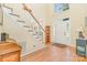 Inviting foyer showcasing hardwood floors, a staircase, and a view of the front door at 10230 Blackstock Rd, Huntersville, NC 28078