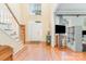 Bright foyer featuring hardwood floors, staircase, and high ceilings, creating a grand entrance at 10230 Blackstock Rd, Huntersville, NC 28078
