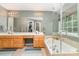 Bright main bathroom with double vanities, walk-in shower, and a soaking tub at 10230 Blackstock Rd, Huntersville, NC 28078