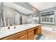 Spa-like main bathroom with double vanities, a large mirror, soaking tub, and walk-in shower at 10230 Blackstock Rd, Huntersville, NC 28078