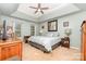 Serene main bedroom boasts tray ceiling, neutral tones, & ample natural light, for a relaxing retreat at 10230 Blackstock Rd, Huntersville, NC 28078