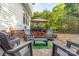 Cozy patio space with outdoor seating, grill area, and lush landscaping at 10230 Blackstock Rd, Huntersville, NC 28078