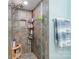 Tiled shower featuring modern fixtures, a corner seat and mosaic tile details at 10230 Blackstock Rd, Huntersville, NC 28078