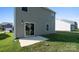 View of the home's rear exterior featuring a small patio and green backyard at 1109 Foxberry Ln, Maiden, NC 28650
