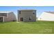Spacious backyard featuring a well-maintained lawn, a sliding glass door, and vinyl siding at 1109 Foxberry Ln, Maiden, NC 28650