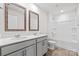Bathroom featuring double sink vanity, a shower-tub combo, and matching mirrors at 1109 Foxberry Ln, Maiden, NC 28650