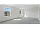 Sunlit carpeted bedroom offers two windows with views of the neighborhood at 1109 Foxberry Ln, Maiden, NC 28650