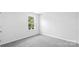 Carpeted bedroom offers a serene retreat with natural light from a single window at 1109 Foxberry Ln, Maiden, NC 28650